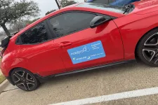 Thumbnail for a red car parked in a parking lot