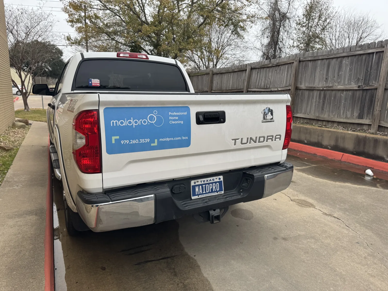 a white truck with a blue sign