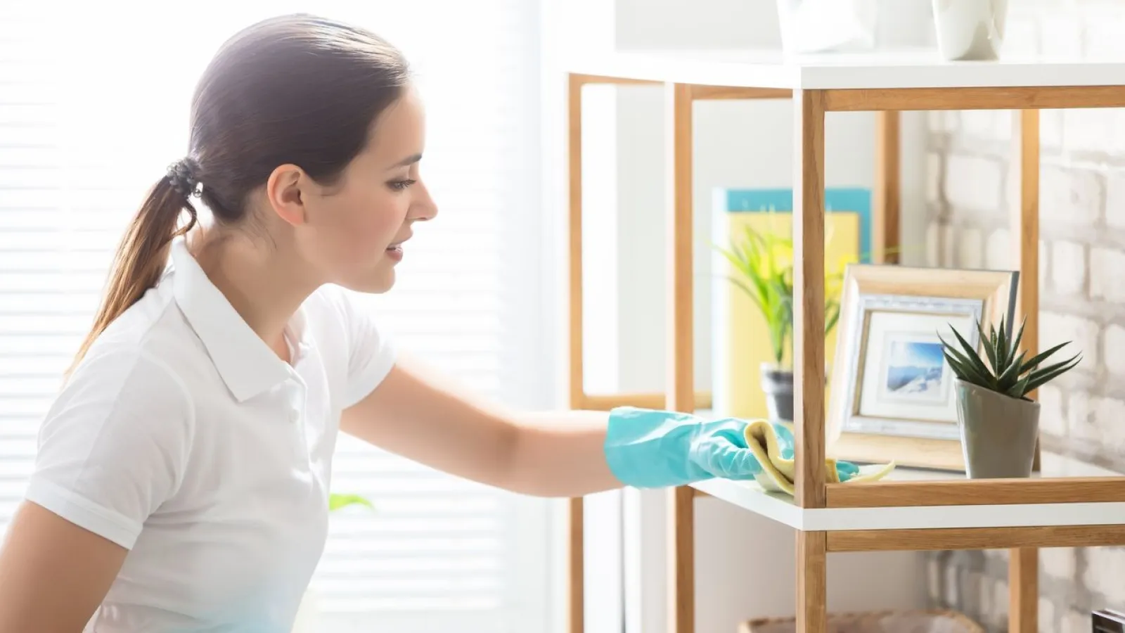 a woman in gloves holding a blue container