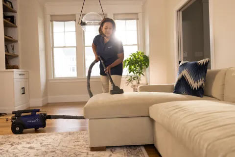 a person vacuuming a living room