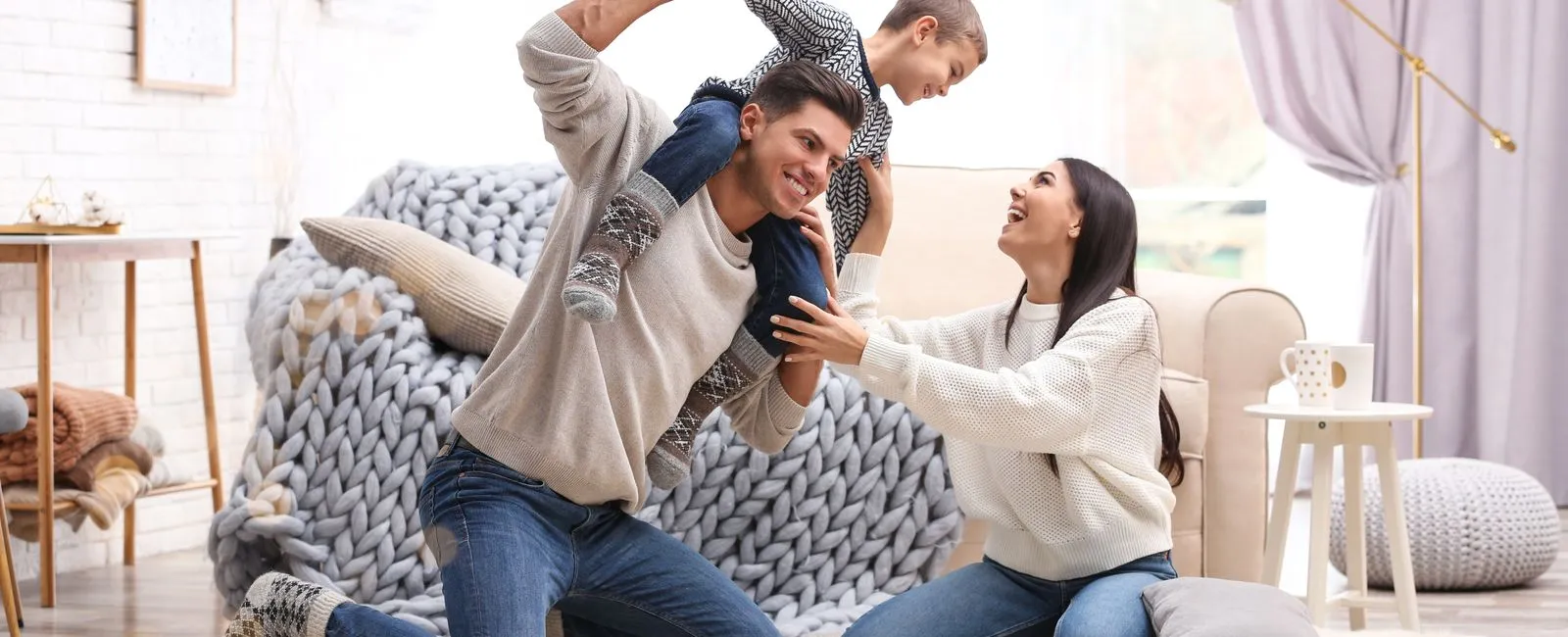 a person holding a person's waist while sitting on a couch
