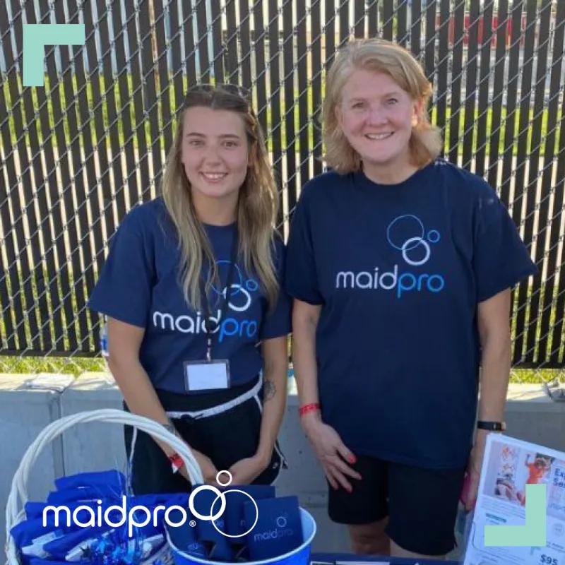 MaidPro League City owner Cindy Pratt and an employee at a local event