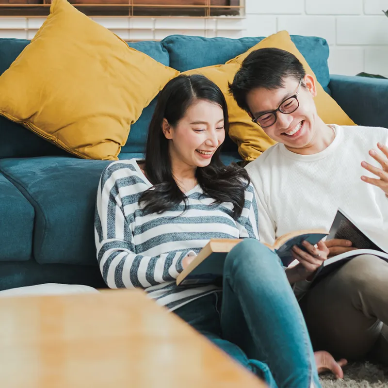 two people reading books and smiling