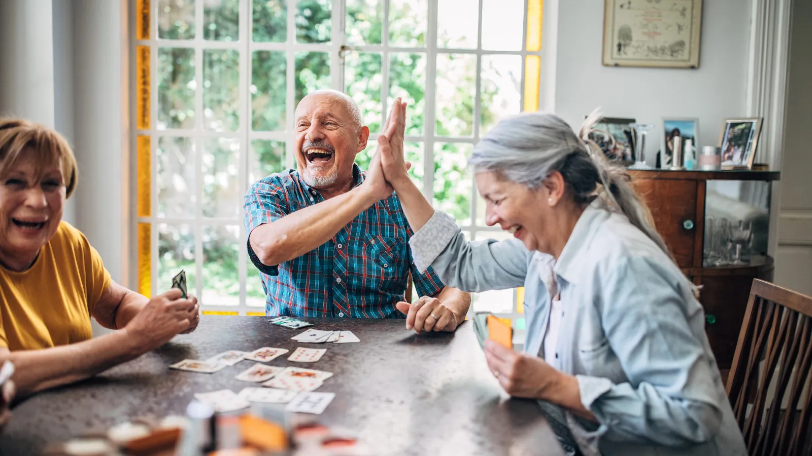 a group of people sitting around a table playing a board game