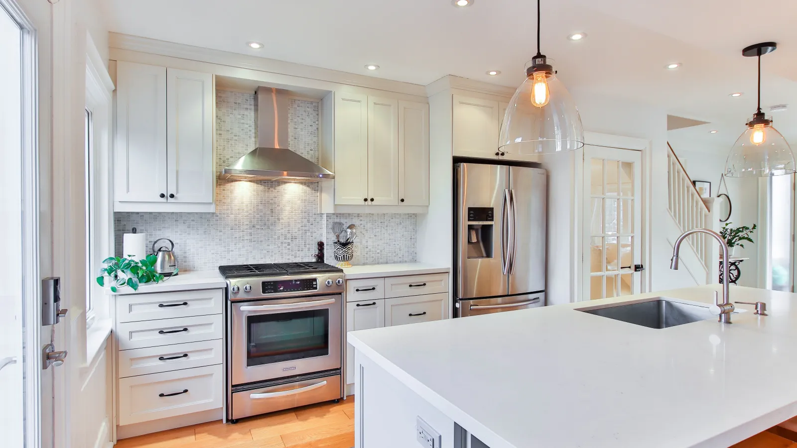a kitchen with white cabinets