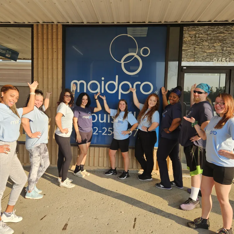 MaidPro Louisville cleaning professionals in front of store sign