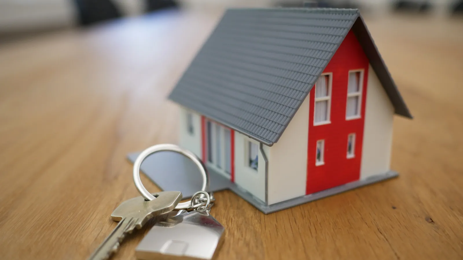 a small house keychain on a table
