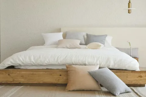a white bed with pillows