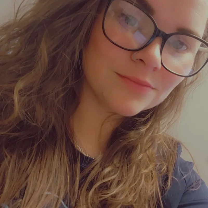 a woman with long hair and glasses